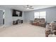 Spacious living room featuring a large tv, ceiling fan, and lots of natural light at 121 Little Kennerly Dr, Mooresville, NC 28115