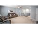 Living room features comfortable seating, ceiling fan and access to the upper level at 121 Little Kennerly Dr, Mooresville, NC 28115