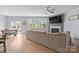 Bright living room with a cozy fireplace, neutral decor, and access to the patio at 121 Little Kennerly Dr, Mooresville, NC 28115