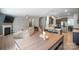 Open concept living space features fireplace, kitchen with island, and staircase to the upper level at 121 Little Kennerly Dr, Mooresville, NC 28115