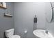 Cozy powder room with decorative shelves, round mirror, toilet and sink at 121 Little Kennerly Dr, Mooresville, NC 28115