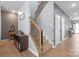 Well-lit stairway with carpeted steps, wooden handrail, and decorative iron spindles at 121 Little Kennerly Dr, Mooresville, NC 28115