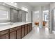Large bathroom with double sink vanity, walk-in shower, and an open doorway to the bedroom at 12110 Anne Blount Aly, Huntersville, NC 28078