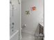 Bright bathroom featuring a tub-shower combo and cute dinosaur-themed wall art at 12110 Anne Blount Aly, Huntersville, NC 28078