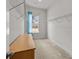 Spacious walk-in closet includes shelving, a bureau, neutral carpet, and a window at 12110 Anne Blount Aly, Huntersville, NC 28078