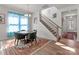 Elegant dining area featuring a round table with chairs, hardwood floors, and an open view of the staircase at 12110 Anne Blount Aly, Huntersville, NC 28078