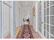 Inviting entryway with hardwood floors, a colorful rug, and view into the open-concept living space at 12110 Anne Blount Aly, Huntersville, NC 28078