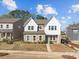 Charming two-story home with white and tan siding, complemented by a well-manicured front yard and sidewalk at 12110 Anne Blount Aly, Huntersville, NC 28078