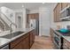 Spacious kitchen showcasing a large island with sink, stainless steel appliances, granite countertops and wooden cabinetry at 12110 Anne Blount Aly, Huntersville, NC 28078