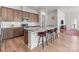 Modern kitchen featuring granite countertops, a kitchen island with seating, stainless steel appliances, and tiled backsplash at 12110 Anne Blount Aly, Huntersville, NC 28078