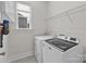 A laundry room featuring modern appliances and ample storage at 12110 Anne Blount Aly, Huntersville, NC 28078