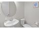 Neat powder room features a pedestal sink with an oval mirror and a toilet with painted walls at 12110 Anne Blount Aly, Huntersville, NC 28078