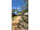 Long driveway leading to a well-kept home, framed by mature trees and lush greenery at 1232 Rosada Dr, Charlotte, NC 28213