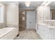 Elegant bathroom with a soaking tub, glass enclosed shower and white cabinets at 12627 Ninebark Trl, Charlotte, NC 28278