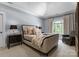 Cozy bedroom with vaulted ceiling, comfortable seating, and a large window at 12627 Ninebark Trl, Charlotte, NC 28278