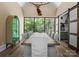 Elegant dining room with hardwood floors, large windows, and rustic wood table setting at 12627 Ninebark Trl, Charlotte, NC 28278