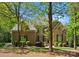 Stunning stone and brick home with lush landscaping and mature trees at 12627 Ninebark Trl, Charlotte, NC 28278