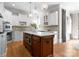 A beautifully lit kitchen with an island featuring storage and a microwave at 12627 Ninebark Trl, Charlotte, NC 28278