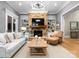 Cozy living room with a stone fireplace, built-in shelving, and plush furnishings at 12627 Ninebark Trl, Charlotte, NC 28278