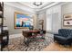 Chic home office with custom shelving, a comfortable chair, and natural light at 12627 Ninebark Trl, Charlotte, NC 28278
