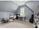 Attic office space featuring a desk, chair, guitar, and ample storage shelves at 12627 Ninebark Trl, Charlotte, NC 28278