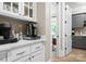 Kitchen pantry with a coffee and beverage bar, white cabinets and counter tops at 12627 Ninebark Trl, Charlotte, NC 28278