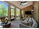 Cozy screened porch with brick accents, comfortable seating, and tranquil outdoor views at 12627 Ninebark Trl, Charlotte, NC 28278