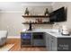 Modern wet bar featuring dark cabinets, granite countertops, and stainless steel beverage cooler at 12627 Ninebark Trl, Charlotte, NC 28278
