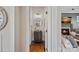 Charming half-bathroom featuring a vintage-style vanity, round mirror, and hardwood floors at 1407 Becklow Ct, Wesley Chapel, NC 28079