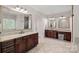 Elegant bathroom featuring dual vanities with granite countertops and framed mirrors at 1407 Becklow Ct, Wesley Chapel, NC 28079