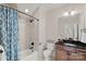 Well-lit bathroom featuring a tub with a shower and a vanity with dark countertop at 1407 Becklow Ct, Wesley Chapel, NC 28079