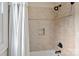Bathroom featuring tiled walls, black fixtures, and a white shower curtain at 1407 Becklow Ct, Wesley Chapel, NC 28079