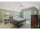 Green bedroom features a double bed, modern furniture, and plenty of light at 1407 Becklow Ct, Wesley Chapel, NC 28079