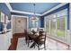 Formal dining room featuring hardwood floors, stylish chandelier and large windows at 1407 Becklow Ct, Wesley Chapel, NC 28079