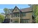 Stunning home featuring a covered balcony, large windows, and a beautifully textured exterior at 1407 Becklow Ct, Wesley Chapel, NC 28079