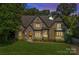 A stately home with a stone entryway, elegant windows, and manicured landscaping at dusk at 1407 Becklow Ct, Wesley Chapel, NC 28079
