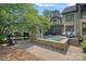Beautiful backyard with pool, spa, stone fireplace and lounging area at 1407 Becklow Ct, Wesley Chapel, NC 28079