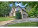Charming home with a stone facade, manicured lawn, attached garage, and a private driveway at 1407 Becklow Ct, Wesley Chapel, NC 28079