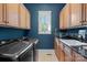 Well-appointed laundry room with modern washer/dryer, ample cabinetry, and a granite countertop sink at 1407 Becklow Ct, Wesley Chapel, NC 28079