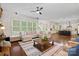 Open-concept living room with expansive windows and seamless flow into the kitchen at 1407 Becklow Ct, Wesley Chapel, NC 28079