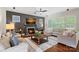 Cozy living room with a fireplace, large windows, and comfortable sectional seating at 1407 Becklow Ct, Wesley Chapel, NC 28079
