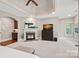Spacious main bedroom boasts tray ceilings, a fireplace, and a cozy seating area at 1407 Becklow Ct, Wesley Chapel, NC 28079