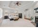 Serene main bedroom featuring a tray ceiling, fireplace, plush carpet, and en-suite bathroom at 1407 Becklow Ct, Wesley Chapel, NC 28079