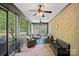 Relaxing screened-in porch with comfortable seating and ceiling fans at 1407 Becklow Ct, Wesley Chapel, NC 28079