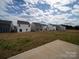 A view of the house exteriors with backyard space with a concrete patio in a community at 14217 Wilson Mac Ln, Charlotte, NC 28278