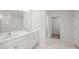 Bathroom featuring double vanity, white cabinets, shower, and hexagonal tile flooring at 14217 Wilson Mac Ln, Charlotte, NC 28278