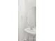 Clean powder room features a pedestal sink and a round mirror at 14217 Wilson Mac Ln, Charlotte, NC 28278