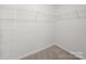 Walk-in closet with carpet floor, white walls, and ventilated shelving for ample storage at 14217 Wilson Mac Ln, Charlotte, NC 28278