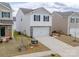 Charming two-story home with white siding, stone accents, a two-car garage, and a well-maintained lawn at 14217 Wilson Mac Ln, Charlotte, NC 28278