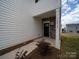 Home entrance featuring a black door, stone accents, white columns, and the house number at 14217 Wilson Mac Ln, Charlotte, NC 28278